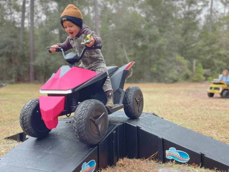 Kid Riding The Pink Mongoose ATV Quad by Tough Trucks For Kids down a play ramp