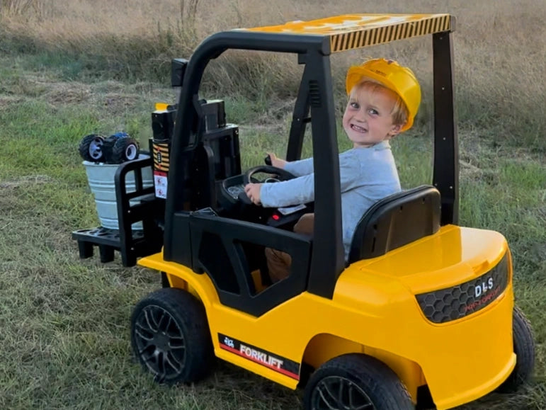 Kid looking on camera, smiling while lifting a Basket full of toys on the Forklift 9000 by Tough Trucks For Kids