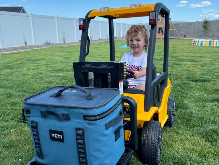 Kid lifting a Yeti Cooler on the Forklift 9000 by Tough Trucks For Kids