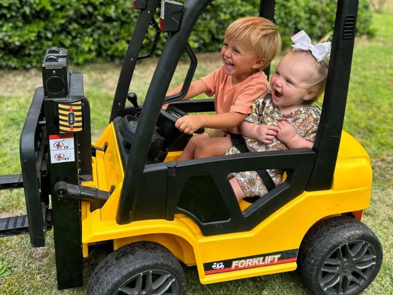 Brother and Sister sharing the seat of the Forklift 9000 by Tough Trucks For Kids