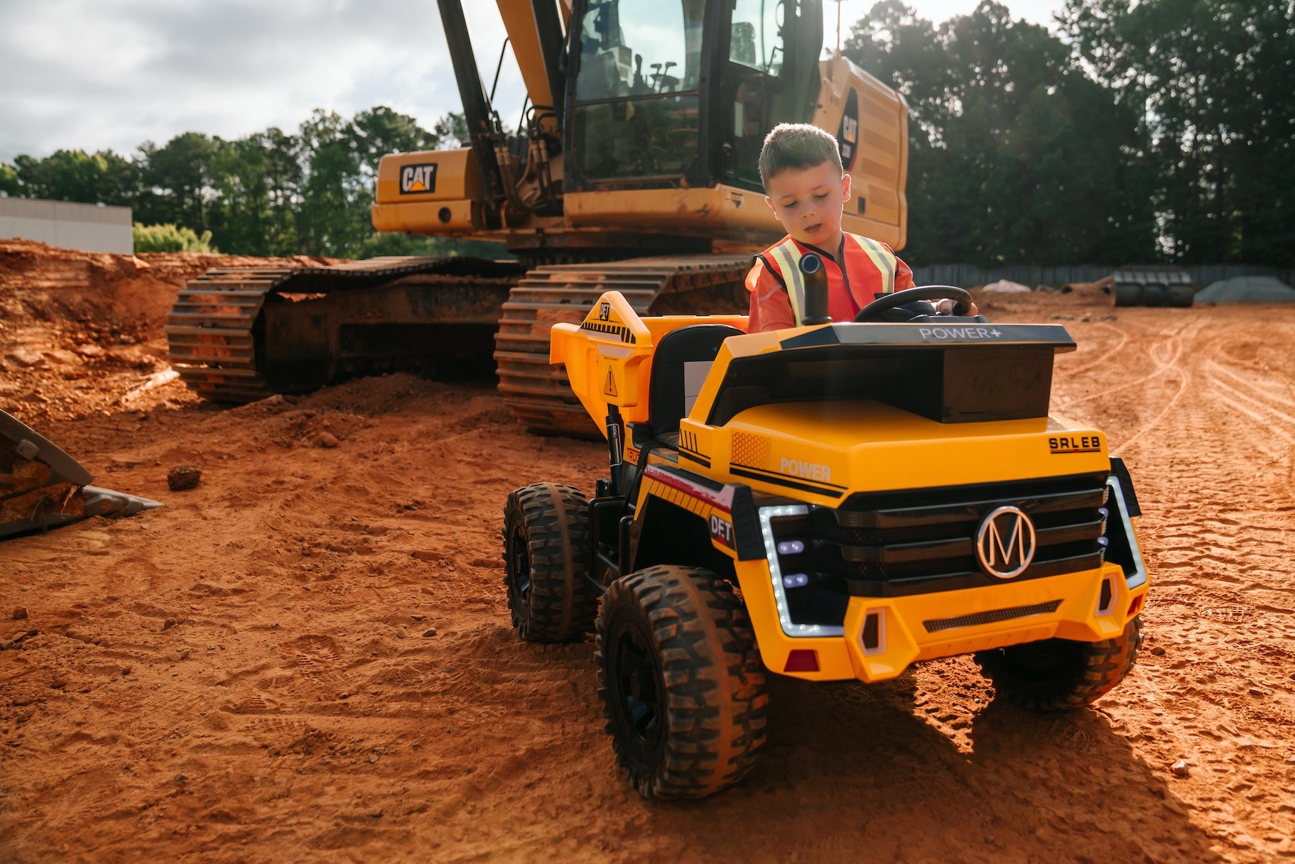 child playing with tough truck in outdoor adventure setting