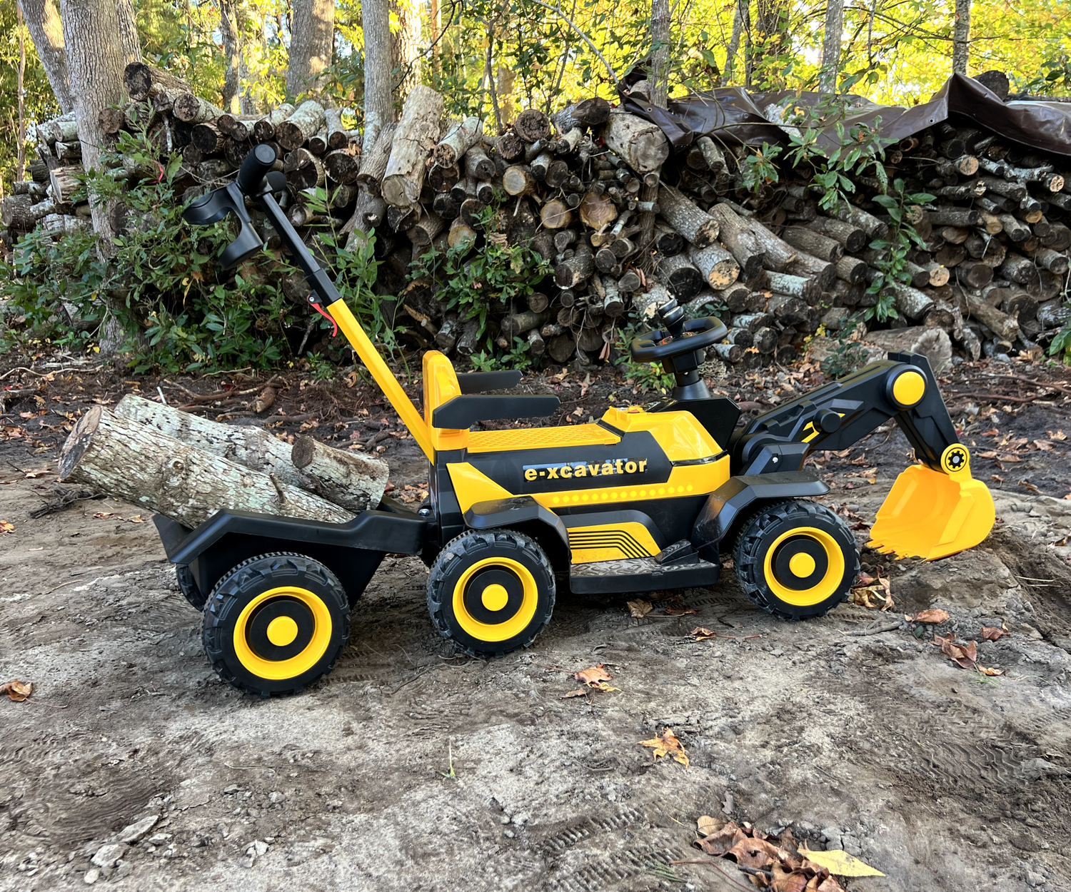 children playing with excavator toys in a sandbox