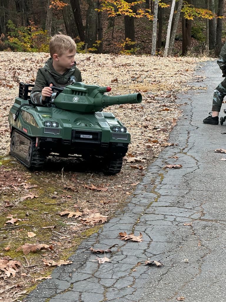 Kid driving green toy tank